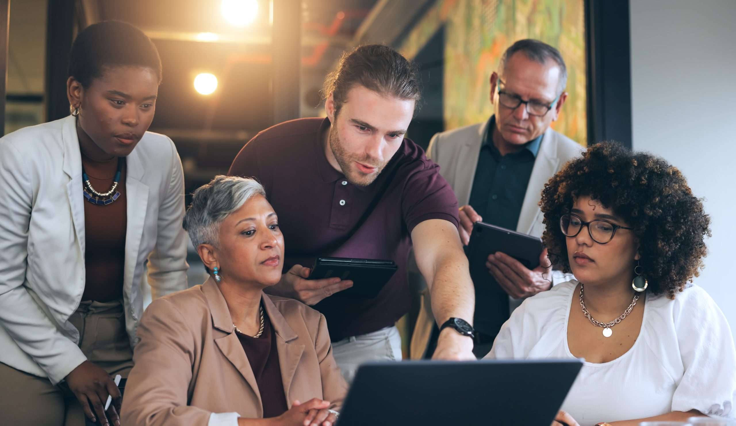 Business professionals collaborating on technology solutions in a modern office